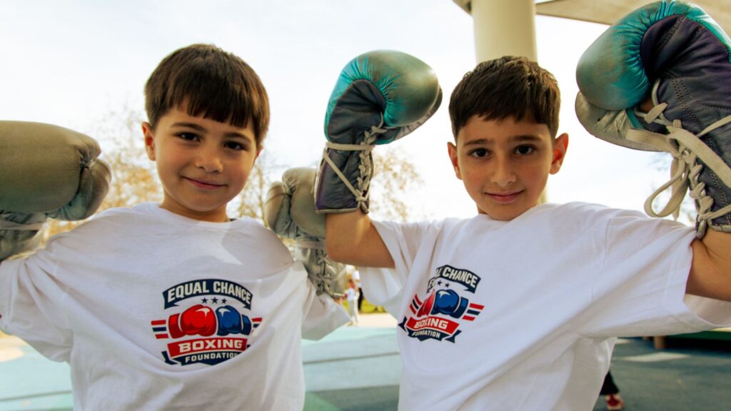 Youth Boxing Program: Teaching Teens How to Roll with the Punches group of kids high fiving after a successful boxing drill